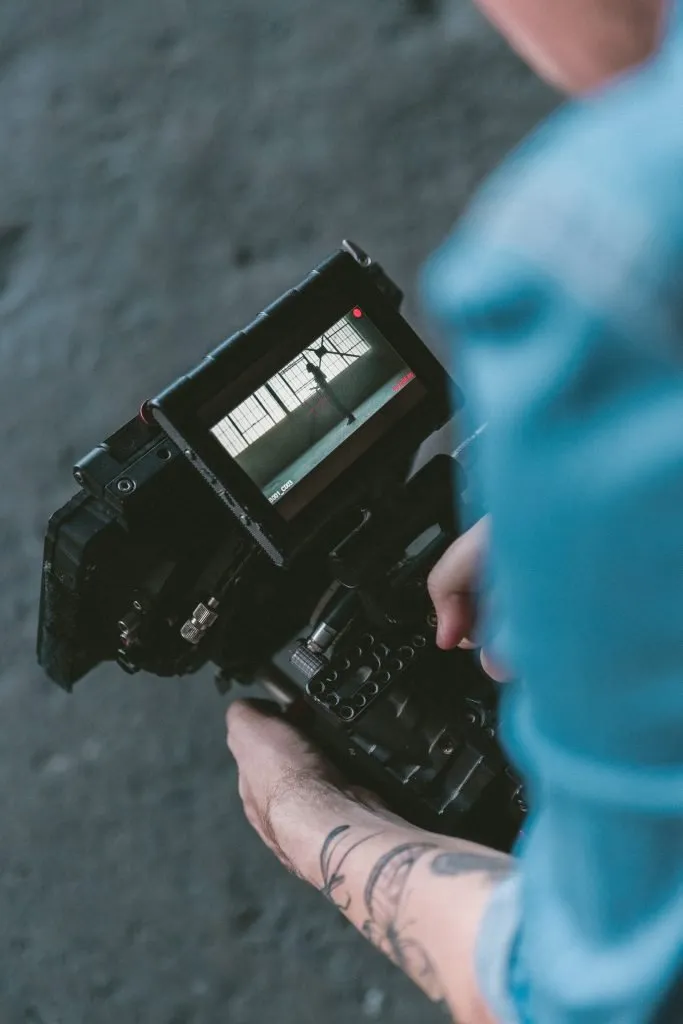 man holding large video camera