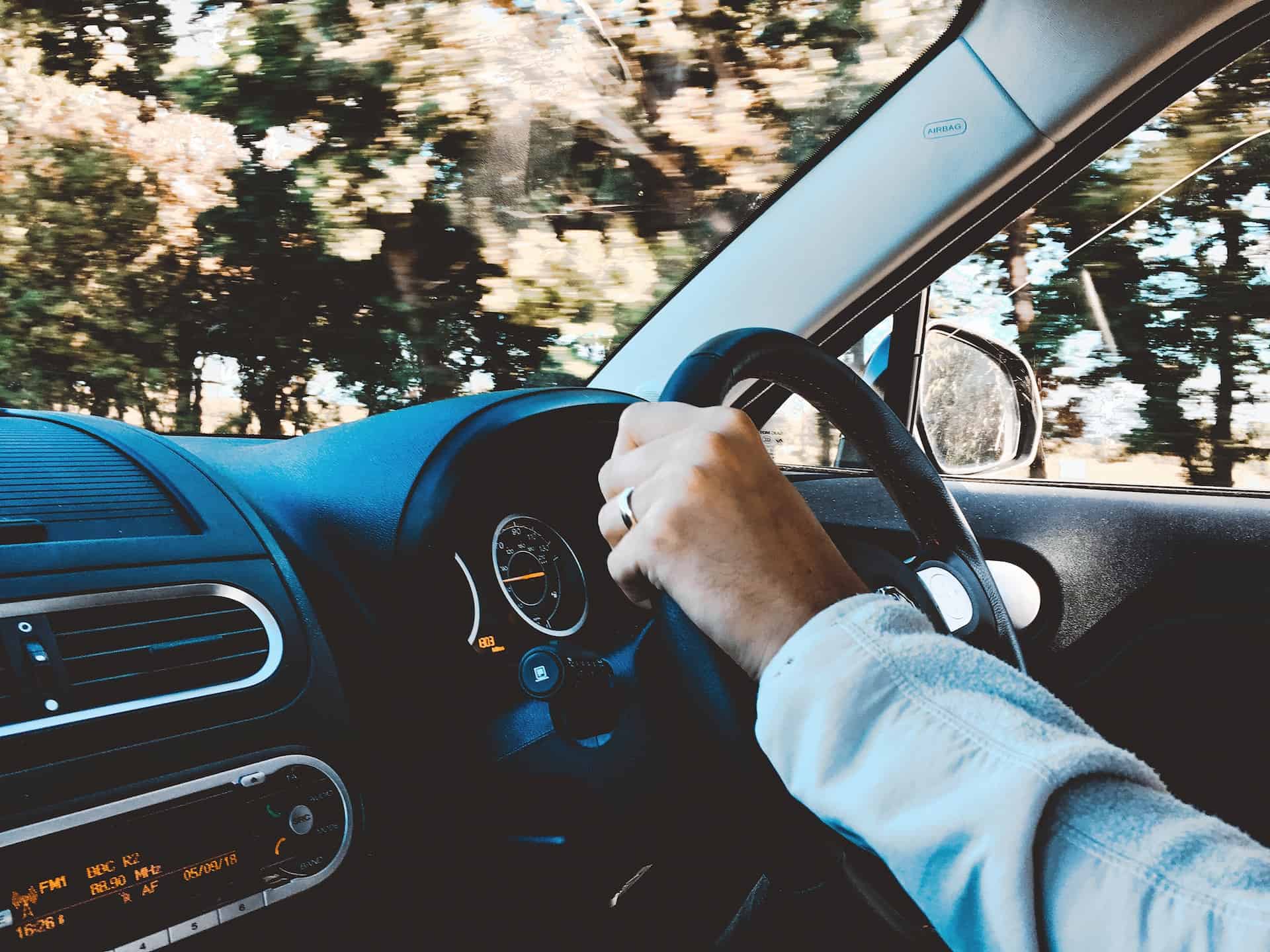 Hand on a steering wheel